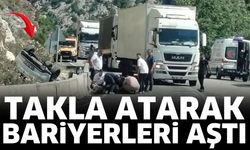 Otomobil takla atarak bariyerleri aştı